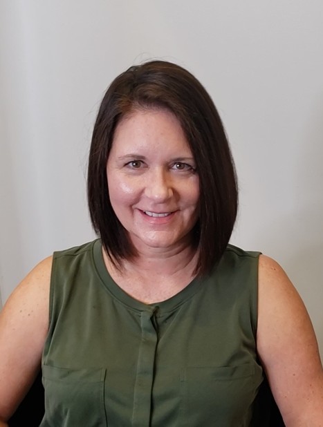 Woman with straight, shoulder-length black hair styled