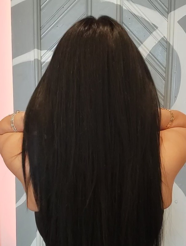 Back view of a person with long, straight dark hair